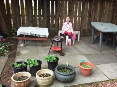 Freya Modelling the Potato Patch (Behind Her) and the Pots